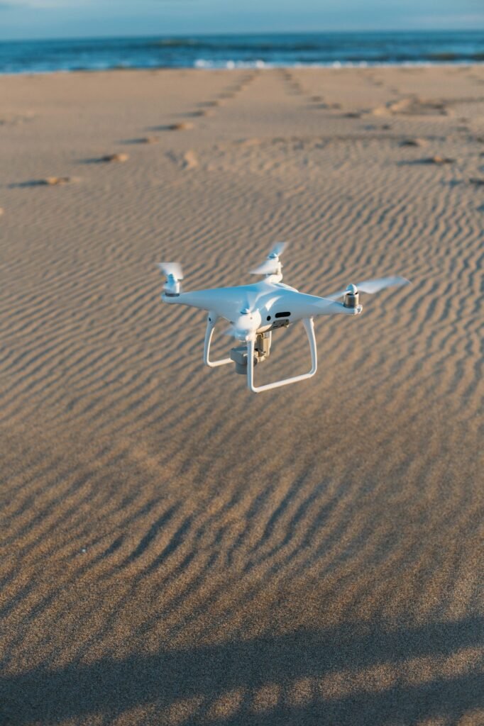 Aerial private drone lands at sand on beach