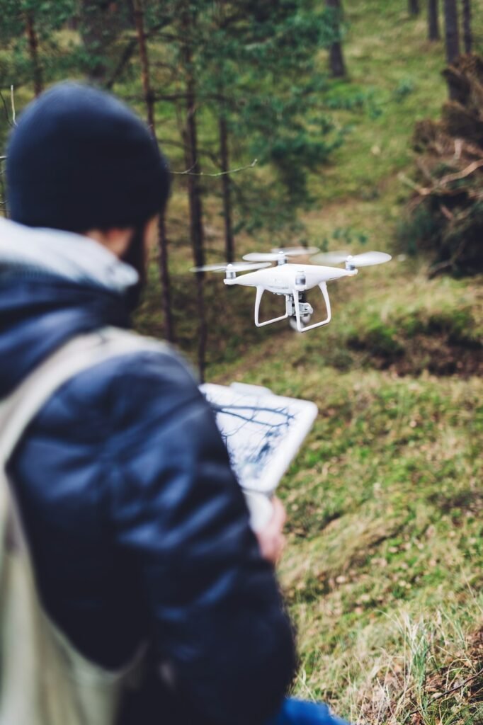 Man operating a drone while trekking in forest